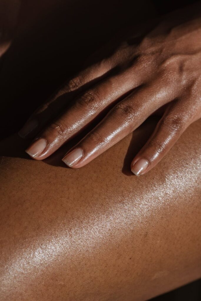 unrecognizable black woman touching leg